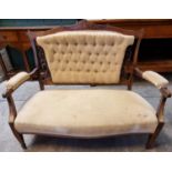 Late Victorian rosewood inlaid parlour sofa, the shaped top above a carved and upholstered button