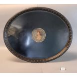 19th Century Pontypool style black Japanned metal oval tray with gilded decoration, the centre