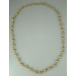 Necklace of 9ct gold beads with satin finish. Length 28 inches (31cm). Approx weight 28.6 grams. (