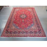 Middle Eastern design Mashad carpet on a mainly red ground with multi-coloured stylised floral and