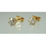 Pair of diamond solitaire earrings set in 18ct gold. Estimated total diamond weight 0.85cts.