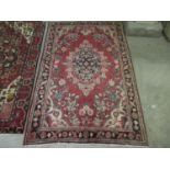 Middle Eastern design Mahal carpet on a pink ground decorated with geometric designs, flowers,