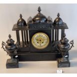 Late 19th Century black slate architectural clock garniture, the clock with three domes, having