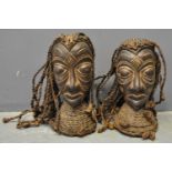 Pair of African carved wooden heads, probably male and female, both with plaited rope hair and