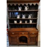 19th Century oak two stage open back dog kennel dresser, the moulded top above iron hooks with