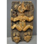 Central/Southern African carved and stained wooden fertility plaque with figural and mask