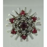 14ct white gold ruby and diamond star shaped cocktail ring with white gold starburst border in mid