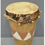 South African carved and polychrome decorated free standing cylindrical tribal drum with skin