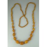 A graduated string of amber beads. The largest approx 25mm and the smallest approx 9mm. Length 50