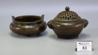Small Chinese patinated bronze censer having open work pierced cover, and lion mask mounts to the