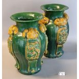Pair of Chinese stoneware baluster shaped vases decorated with relief panels of four clawed