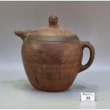 A rustic terracotta baluster shaped teapot or jug with painted banded decoration, loop handle, metal