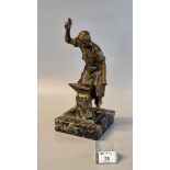 Patinated probably bronze figure of a blacksmith at work with his anvil, on a veined black marble