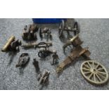 Box containing cast metal and brass replicas of cannons, coracle man, Welsh mining figure etc. (B.P.