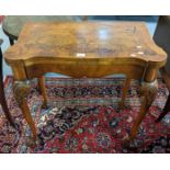 Reproduction walnut fold over card table in George II style with cross banding, guinea wells and