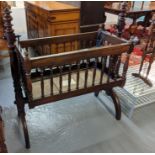 Victorian mahogany child's crib with turned spindles and end supports on outswept legs. Overall