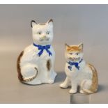 Two late 19th/early 20th century Staffordshire pottery seated cats, one with hollow base and free