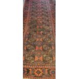 Turkman runner on an orange ground with geometric and lozenge decoration inset with flowers and