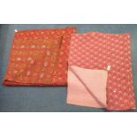 Two vintage cotton printed patterned quilts; one red ground reversible with paisley design and the