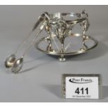 Silver plated shell design sugar nips, together with another silver plated bottle stand decorated