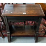 Mahogany low devotional desk with trestle ends and under shelf below a hinged sloped front. 60cm
