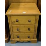 Natural pine bedside chest or lamp table with three cock beaded drawers having turned knobs. 46cm