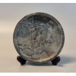 Bronzed spelter dish, relief decorated with figure in a garden. 18.5cm diameter approx. General wear