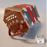 Mahogany concertina with ivorine buttons to each end and checkered inlaid decoration. (B.P. 21% +