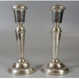 Pair of 20th Century silver candlesticks on tapering shafts and circular beaded bases by B & Co