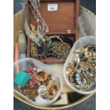 Tub of assorted costume jewellery to include earrings, bracelets, carved box with beads, brooches,