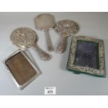 Collection of silver repousse and engine turned hand mirrors, one decorated with exotic birds,