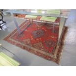 Middle Eastern design red ground carpet, having central medallion flanked by floral and geometric