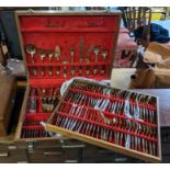 Cased canteen of Thai bronze cutlery, a comprehensive set, fitted into two trays with pieces also in