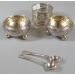 Silver plated pierced napkin ring, together with a pair of silver salts on ball feet with spoons.