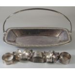 Silver plated pierced single handled basket comprising assorted silver napkin rings. (8) (B.P. 21% +