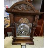 Early 20th Century oak two train architectural design mantel clock having silvered dials with gilded