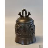 Chinese patinated bronze temple bell, decorated in relief with dragons amongst cloud. 19.5cm high