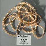 Three strand simulated pearl necklace. (B.P. 21% + VAT)