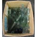 Box containing various vintage glass bottles of various sizes, one marked 'Hoe's Sauce' and two blue