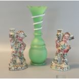 Green glass vase decorated with an entwined snake, together with two similar pottery figures of