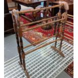 Stained beech towel horse with arched ends. 62cm wide approx. (B.P. 21% + VAT)