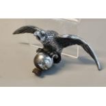 Chromed car mascot in the form of an eagle with outstretched wings standing on a sphere. (B.P. 21% +