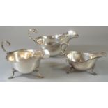 Three Georgian style silver sauce boats, all on shell cabriole legs and hoof feet, two with