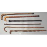 Collection of vintage walking stick/canes, one with entwined snake shaft and another with African