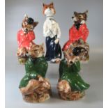 A collection of Staffordshire pottery figurines in the form of novelty foxes in fitted clothing. (5)