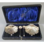 A cased set of shell shaped silver salts with their spoons, Chester hallmarks. (B.P. 21% + VAT)
