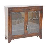 A carved oak low bookcase / display cabinet