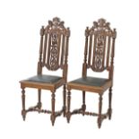 A pair of Carolean carved oak hall chairs