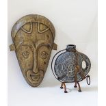 Wooden mask and a ceramic vase