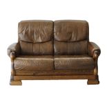 An oak provincial style two seater sofa